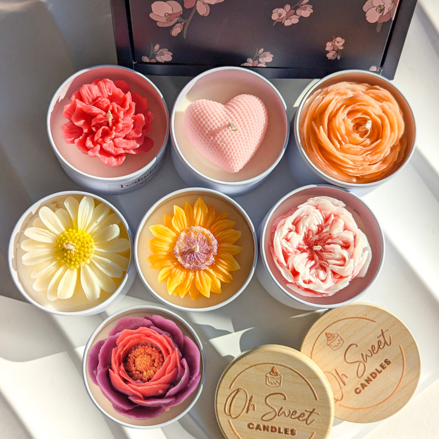 Hand-poured floral tin candle with carnation decoration and notes of pomegranate, lily, and raspberry.